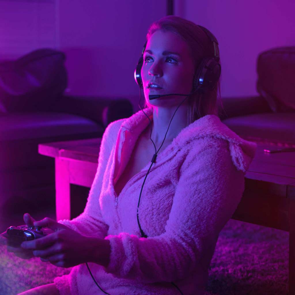 woman gaming in pink light