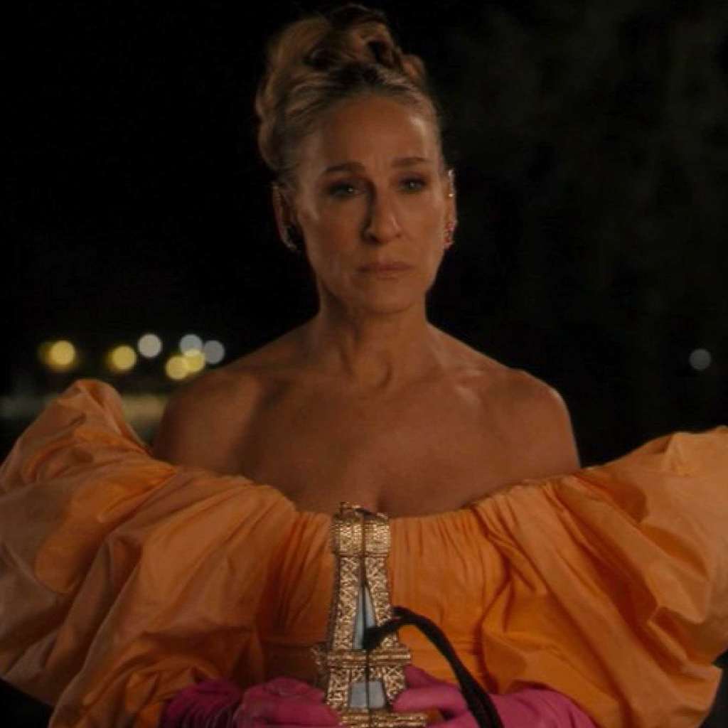 carrie in orange dress on the bridge